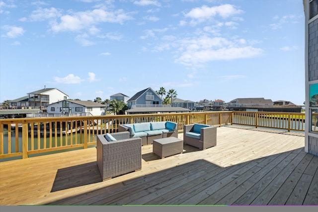 wooden terrace with an outdoor living space and a water view