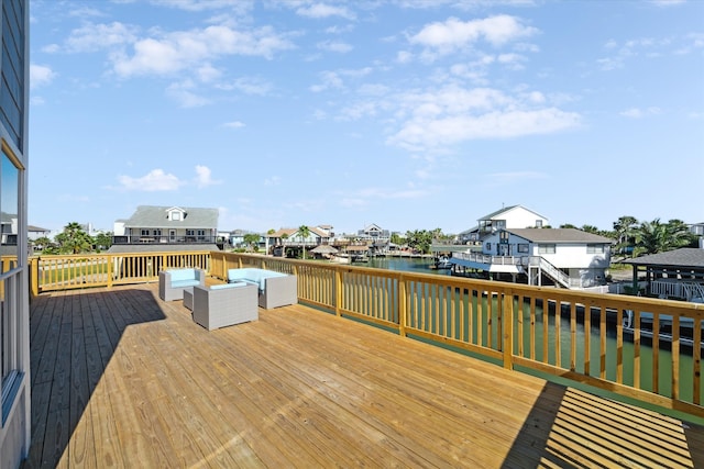 deck featuring an outdoor hangout area and a water view