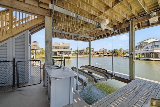 view of dock featuring a water view and sink