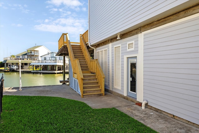 exterior space featuring a water view and a yard