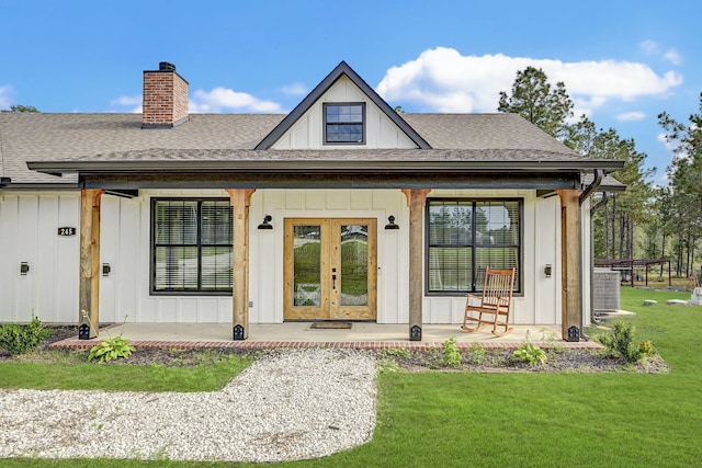 exterior space with a yard, central AC, french doors, and a porch