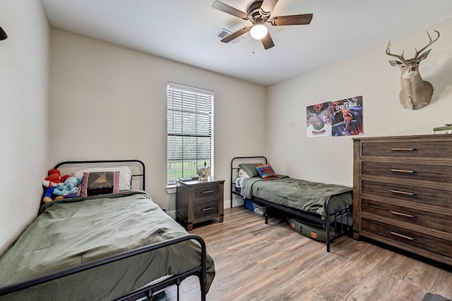 bedroom with ceiling fan and light hardwood / wood-style floors