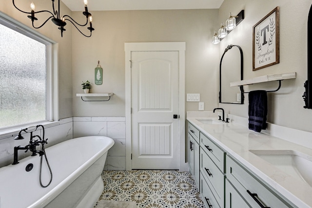 bathroom with plenty of natural light, tile patterned flooring, a bath, and an inviting chandelier