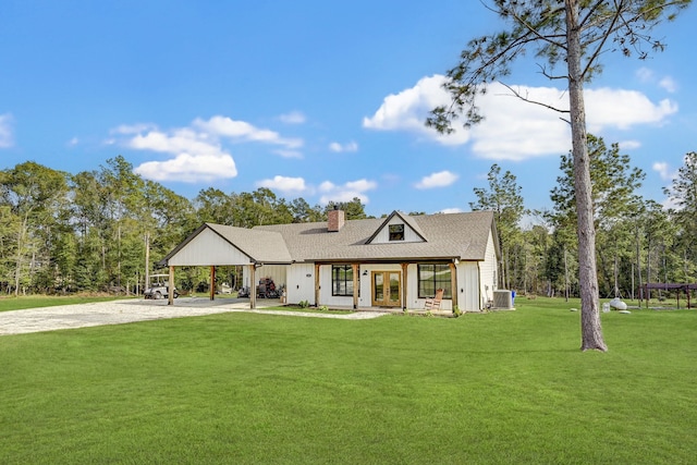 back of property featuring central AC unit, a lawn, and french doors