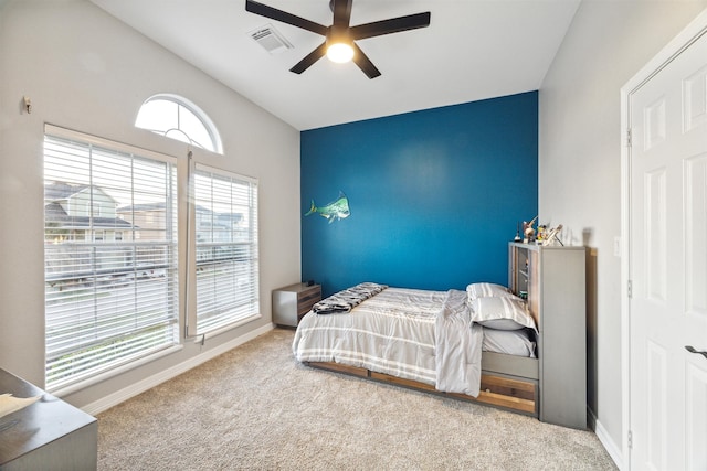 carpeted bedroom with ceiling fan and lofted ceiling