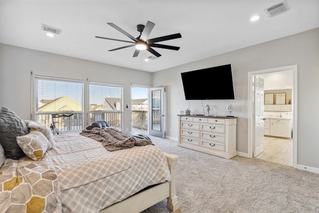 bedroom with access to exterior, light colored carpet, ceiling fan, and ensuite bathroom