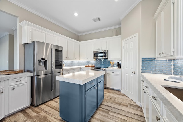 kitchen featuring white cabinets, a center island, and stainless steel appliances