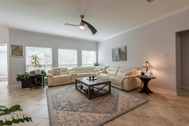 tiled living room featuring ceiling fan, a textured ceiling, and ornamental molding