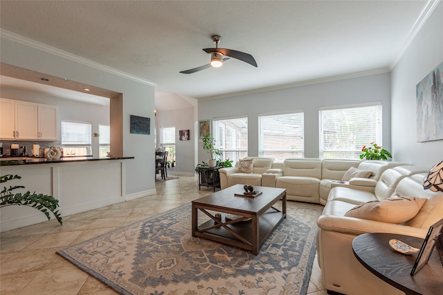 living room featuring plenty of natural light, ceiling fan, light tile patterned flooring, and crown molding