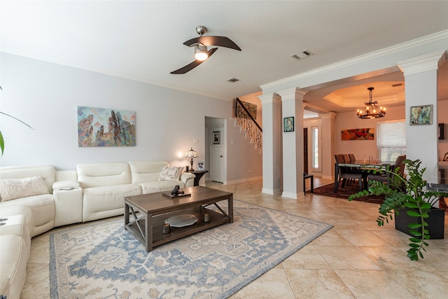 tiled living room with ceiling fan with notable chandelier and ornamental molding