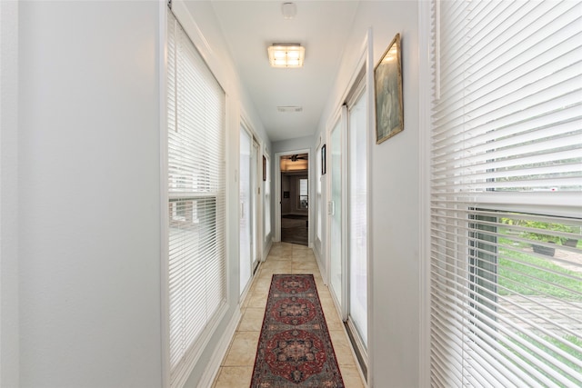 hall featuring light tile patterned flooring