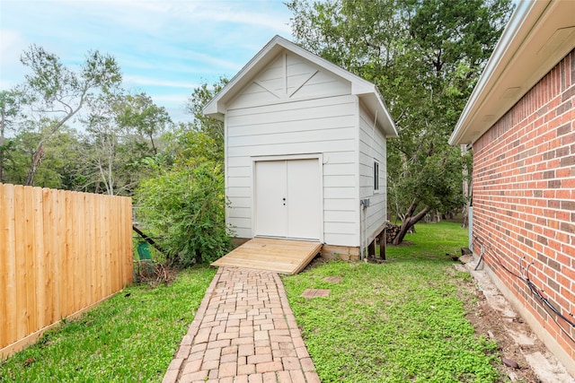 view of outbuilding featuring a lawn