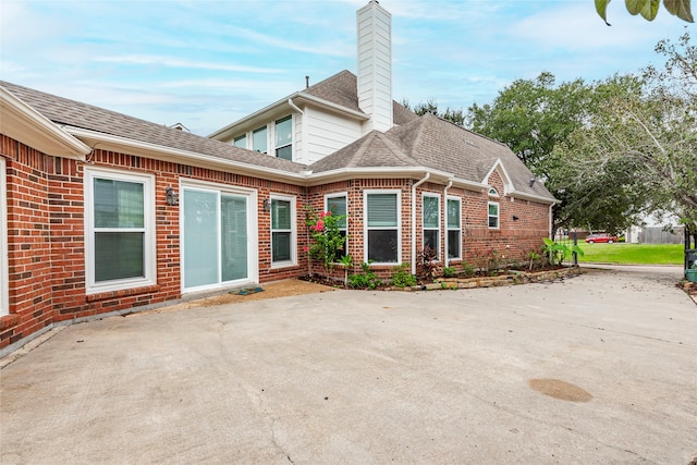 back of house with a patio