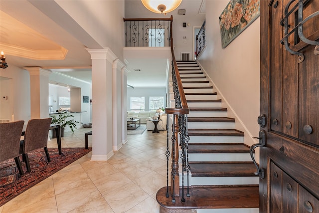 foyer entrance featuring ornamental molding and light tile patterned floors