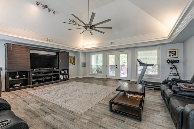 living room with french doors, light wood-type flooring, ceiling fan, and crown molding