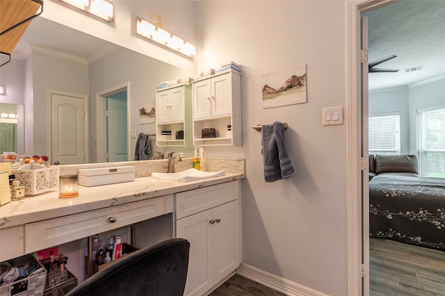 bathroom with vanity, wood-type flooring, a textured ceiling, and ornamental molding