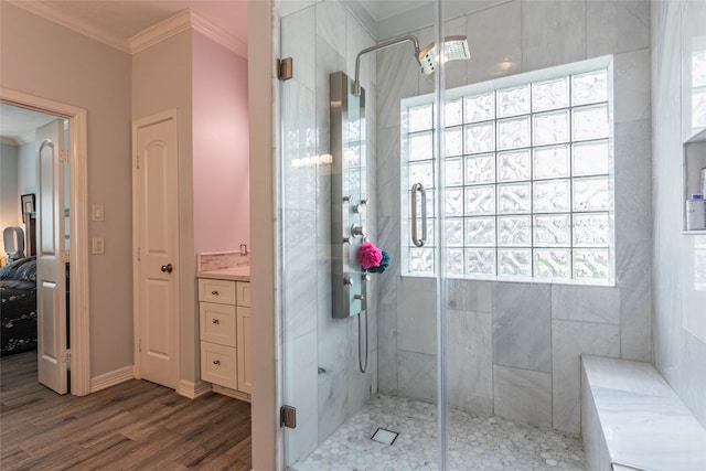 bathroom featuring crown molding, hardwood / wood-style floors, vanity, and an enclosed shower