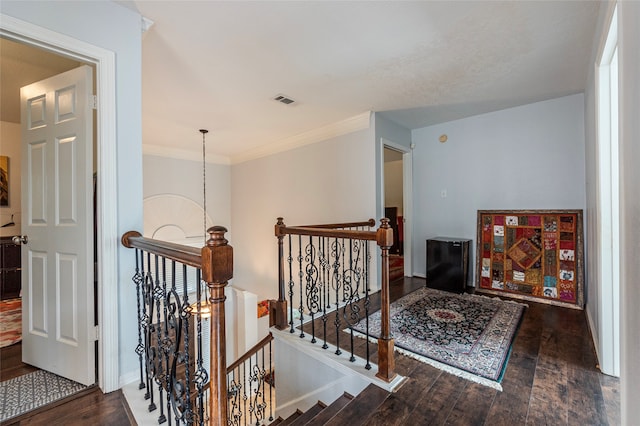 corridor featuring ornamental molding and dark wood-type flooring