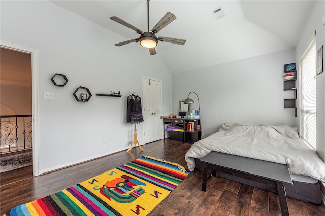 bedroom with dark hardwood / wood-style flooring, vaulted ceiling, and multiple windows