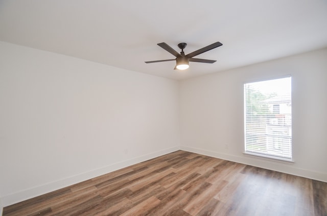 empty room featuring hardwood / wood-style flooring and ceiling fan