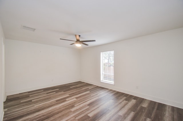 spare room with ceiling fan and dark wood-type flooring