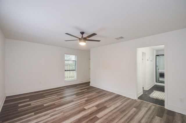 unfurnished room featuring ceiling fan and dark wood-type flooring