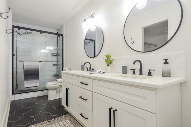 bathroom with tile patterned floors, toilet, decorative backsplash, a shower with door, and vanity