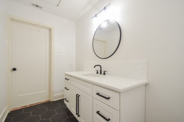 bathroom with tile patterned floors and vanity