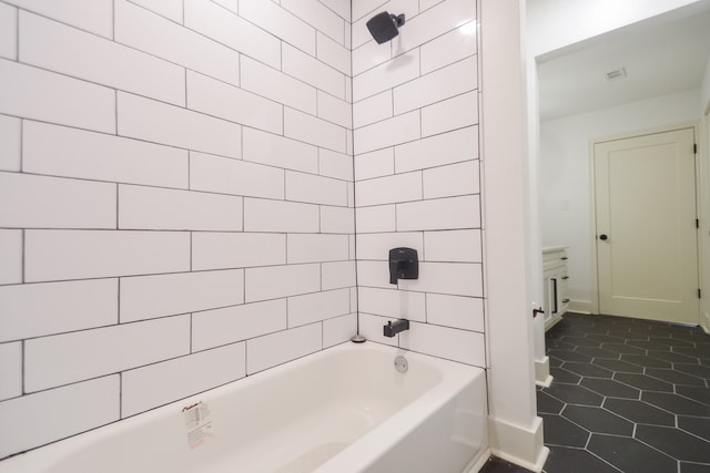 bathroom with tile patterned flooring and tiled shower / bath