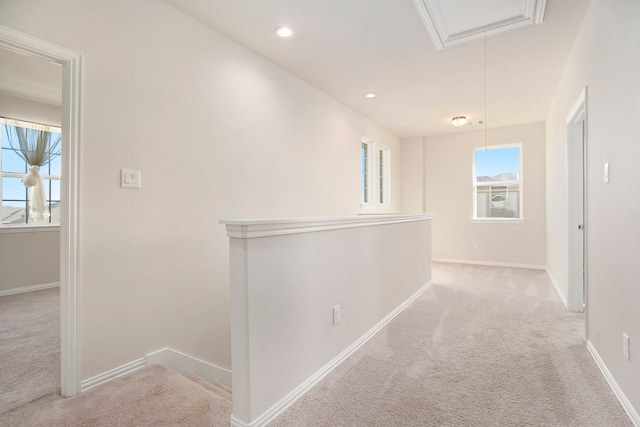 hallway featuring light colored carpet