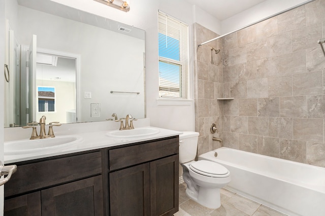 full bathroom featuring tile patterned floors, vanity, toilet, and tiled shower / bath