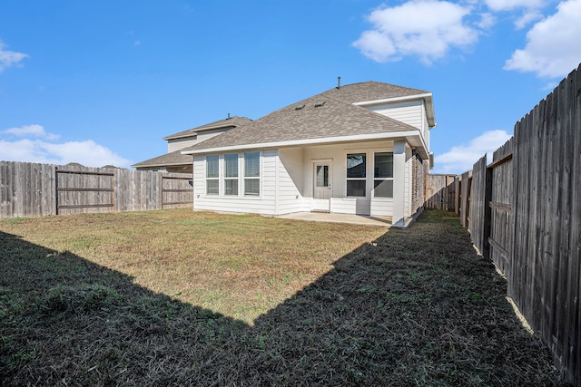 rear view of property with a patio area and a yard