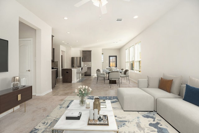 living room featuring ceiling fan and light carpet