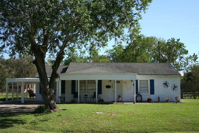 ranch-style home featuring a carport, covered porch, and a front lawn