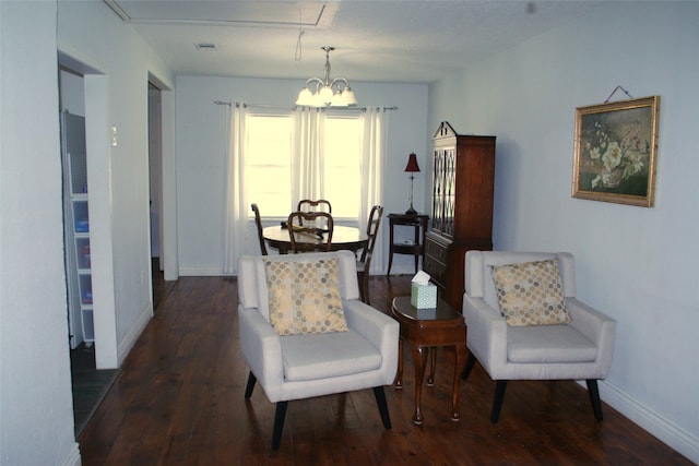 sitting room featuring a notable chandelier and dark hardwood / wood-style flooring