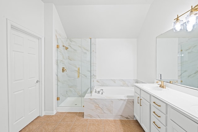 bathroom featuring tile patterned floors, separate shower and tub, vanity, and lofted ceiling