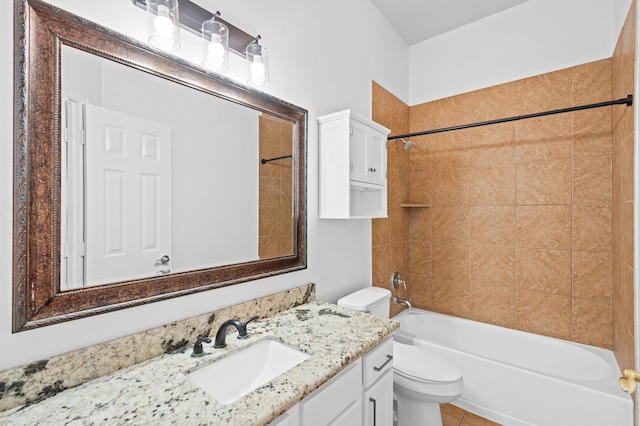 full bathroom featuring vanity, tiled shower / bath combo, toilet, and tile patterned flooring