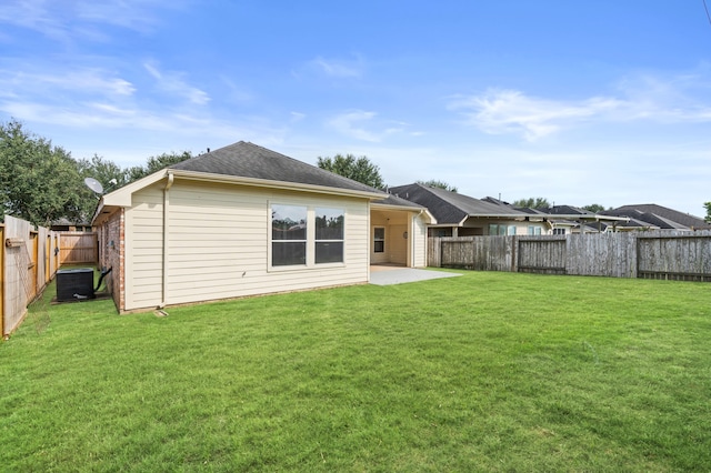 back of house featuring a yard, cooling unit, and a patio