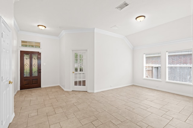 entrance foyer featuring lofted ceiling, crown molding, and a wealth of natural light