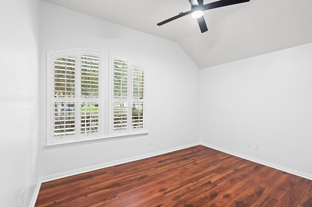 unfurnished room featuring dark hardwood / wood-style floors, vaulted ceiling, and ceiling fan