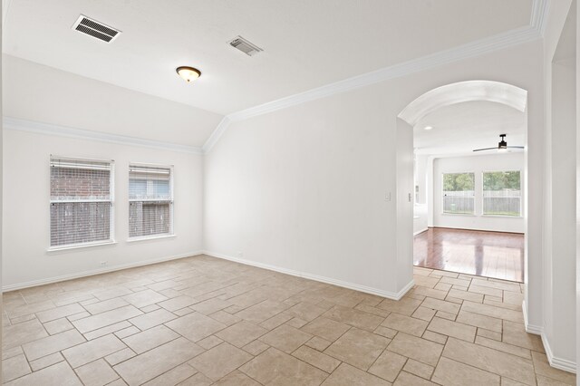 unfurnished room with ceiling fan, vaulted ceiling, and ornamental molding