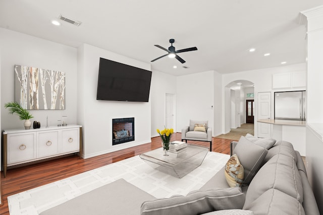 living room featuring light hardwood / wood-style flooring and ceiling fan