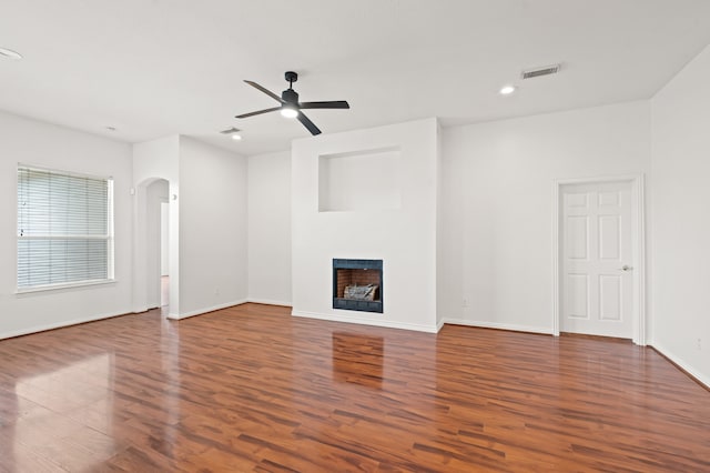 unfurnished living room with ceiling fan and dark hardwood / wood-style flooring