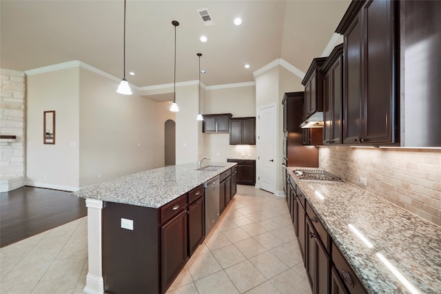 kitchen with a kitchen island with sink, pendant lighting, decorative backsplash, appliances with stainless steel finishes, and ornamental molding