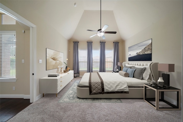 bedroom featuring high vaulted ceiling, multiple windows, dark wood-type flooring, and ceiling fan