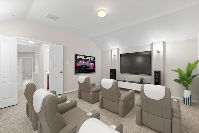 carpeted home theater room featuring lofted ceiling