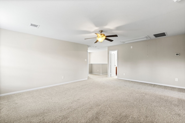 carpeted spare room with ceiling fan