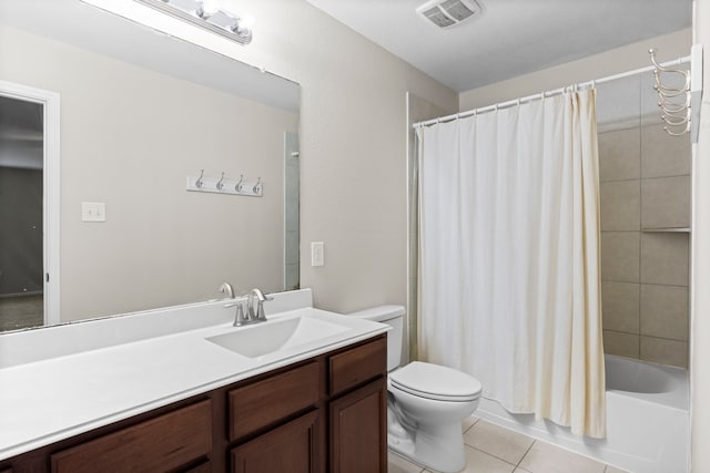 full bathroom with tile patterned flooring, shower / bath combo, toilet, and vanity