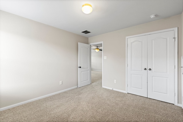 unfurnished bedroom with light carpet and a closet