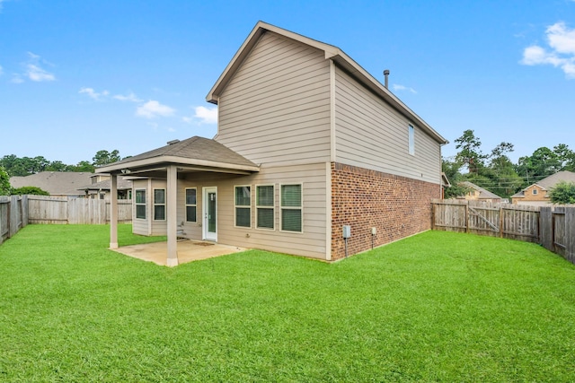 back of property featuring a yard and a patio